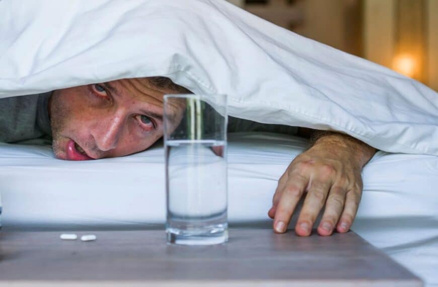 Man in bed sick with allergies