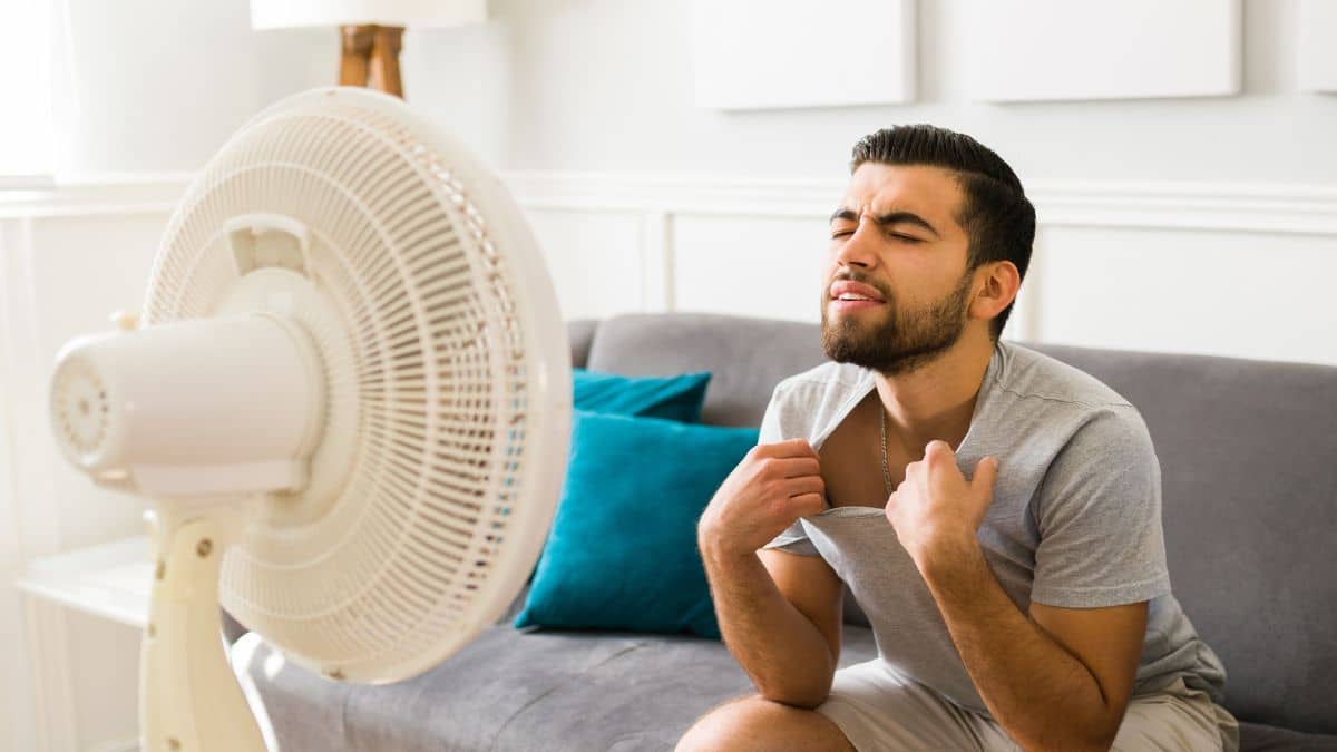 Man in front of fan during heat wave