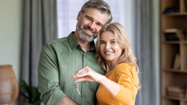 Couple happily holding keys