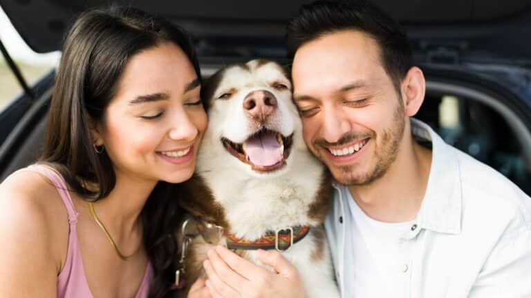 Happy couple hugging dog