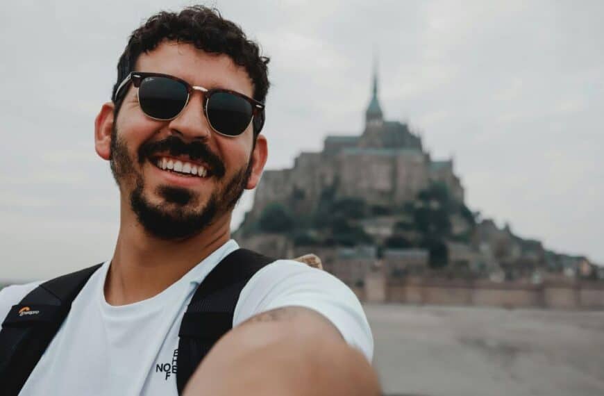 Man taking selfie in front of mont saint michael