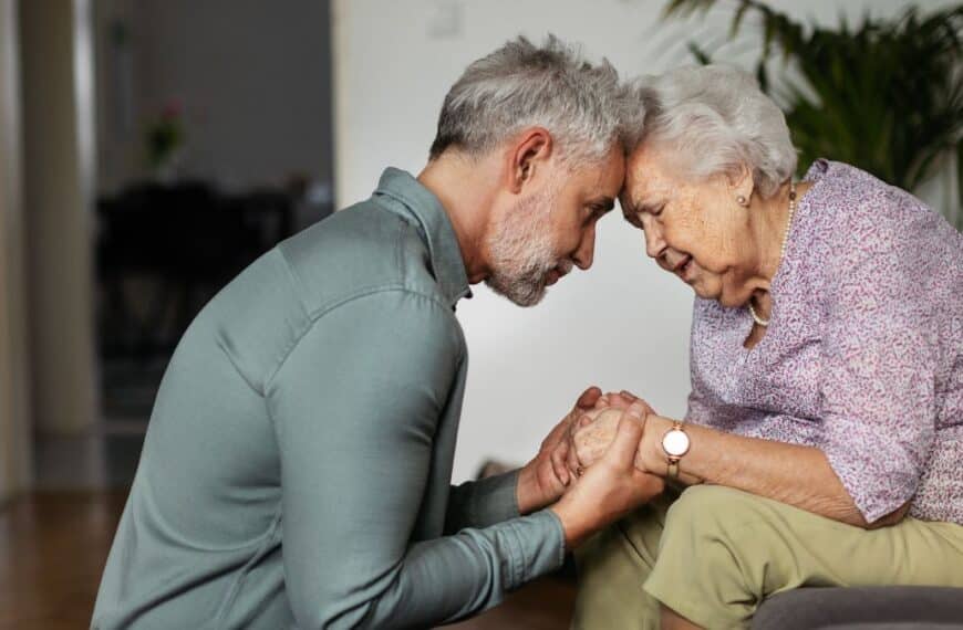Mature man comforting elderly woman